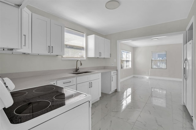 304 E Hanlon St, Tampa, FL 33604 - kitchen with a sink, electric stove, light marble finish flooring, and white cabinets