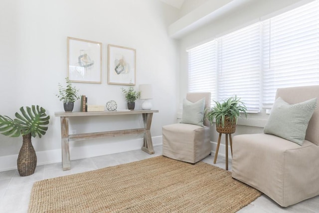 living area with tile patterned flooring and baseboards