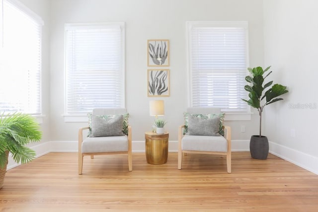 sitting room featuring light wood finished floors and baseboards