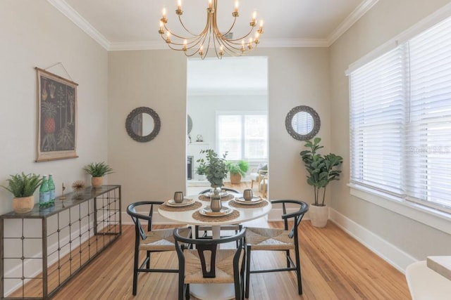 dining space featuring light wood-type flooring, baseboards, and ornamental molding