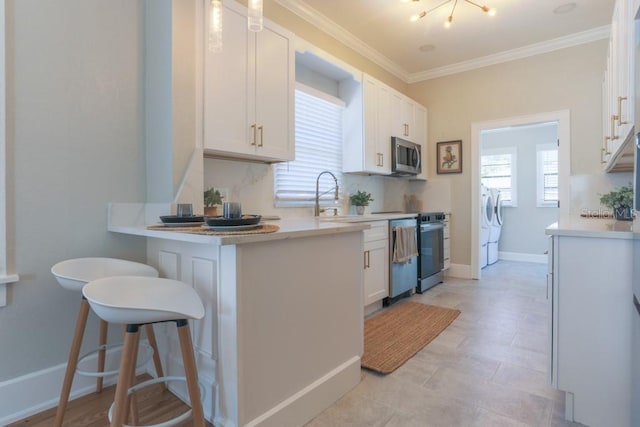 kitchen featuring white cabinetry, stainless steel microwave, plenty of natural light, and separate washer and dryer