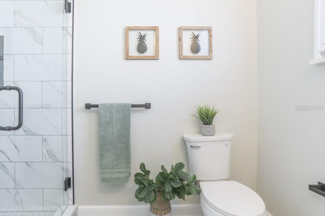 full bath with a shower stall, toilet, and baseboards