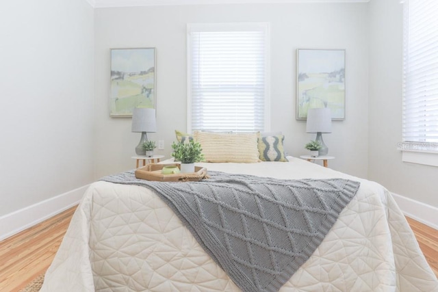 bedroom with baseboards and light wood-style floors