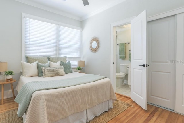 bedroom with ceiling fan, light wood-style flooring, ensuite bathroom, and ornamental molding