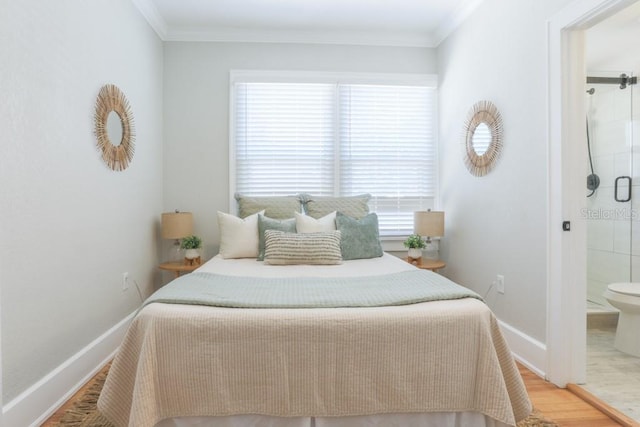 bedroom featuring wood finished floors, baseboards, and ornamental molding