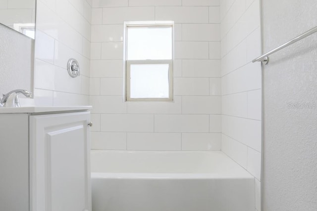 bathroom with vanity and a textured wall