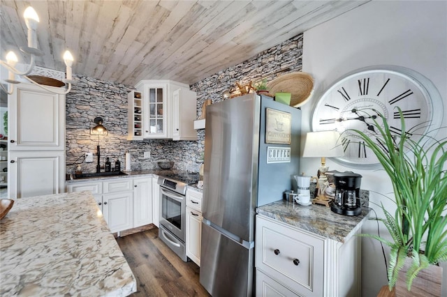 kitchen featuring dark wood finished floors, appliances with stainless steel finishes, white cabinets, glass insert cabinets, and wood ceiling