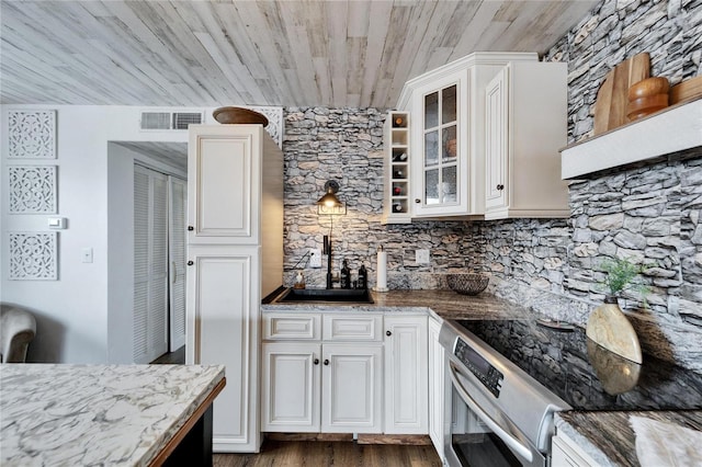 kitchen with visible vents, glass insert cabinets, wooden ceiling, stainless steel range with electric cooktop, and white cabinets