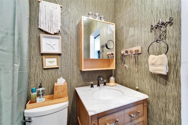 bathroom with toilet and vanity