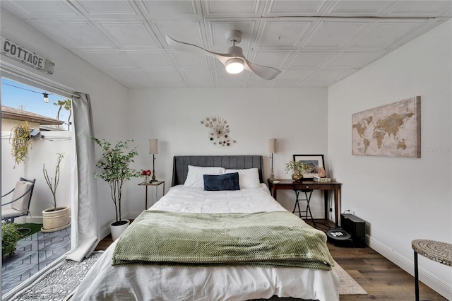 bedroom featuring wood finished floors and baseboards