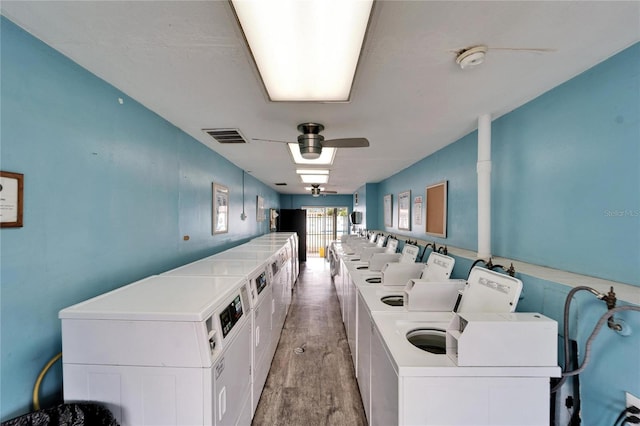 common laundry area featuring visible vents, light wood finished floors, a ceiling fan, and washer and clothes dryer