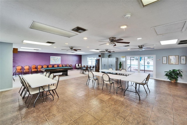 dining area with visible vents, a textured ceiling, and baseboards