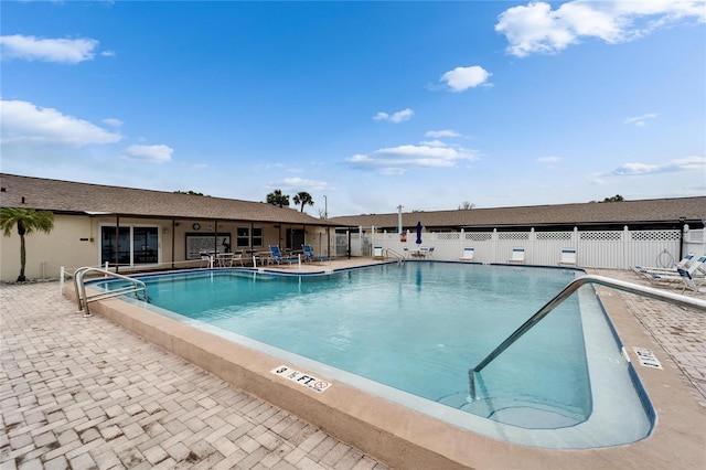 pool featuring a patio and fence