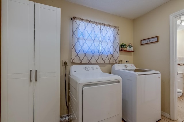 washroom with washing machine and clothes dryer