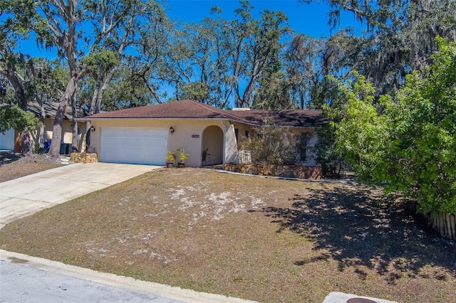 view of front of property featuring stucco siding, a garage, and concrete driveway