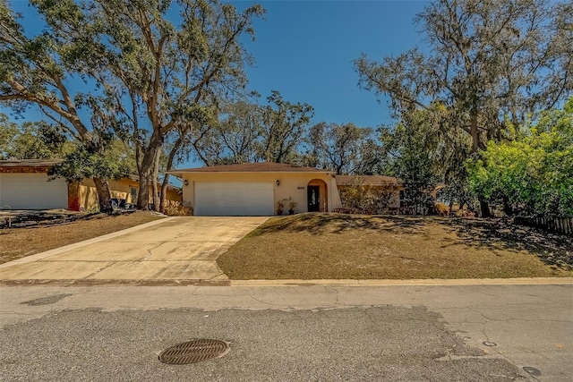 view of front of home featuring stucco siding, concrete driveway, and a garage