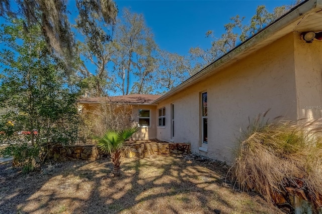 view of side of home featuring stucco siding