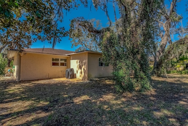 rear view of house with stucco siding