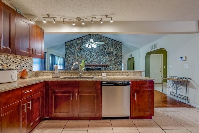 kitchen featuring light stone counters, visible vents, ceiling fan, a sink, and dishwasher