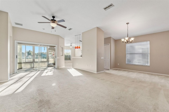 unfurnished living room featuring baseboards, ceiling fan with notable chandelier, visible vents, and light carpet