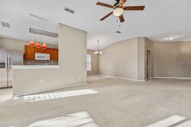 living area with visible vents, light colored carpet, and ceiling fan with notable chandelier