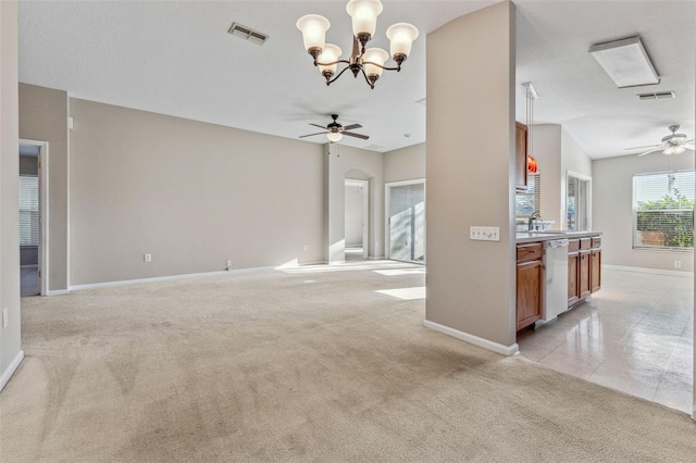 unfurnished living room featuring light carpet, visible vents, and ceiling fan with notable chandelier