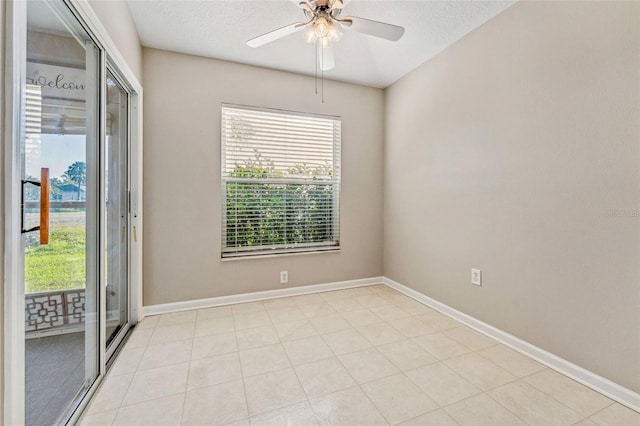 unfurnished room featuring a textured ceiling, baseboards, and a ceiling fan