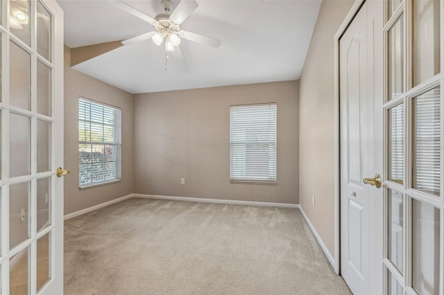 unfurnished room featuring carpet flooring, french doors, a ceiling fan, and baseboards