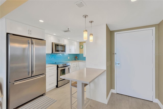 kitchen featuring stainless steel appliances, tasteful backsplash, white cabinets, and light countertops