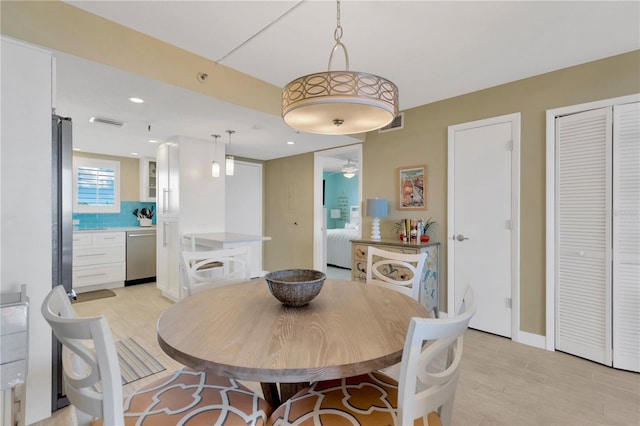 dining area with light wood-style flooring, recessed lighting, and visible vents