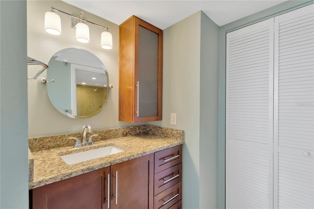 full bath featuring a closet and vanity