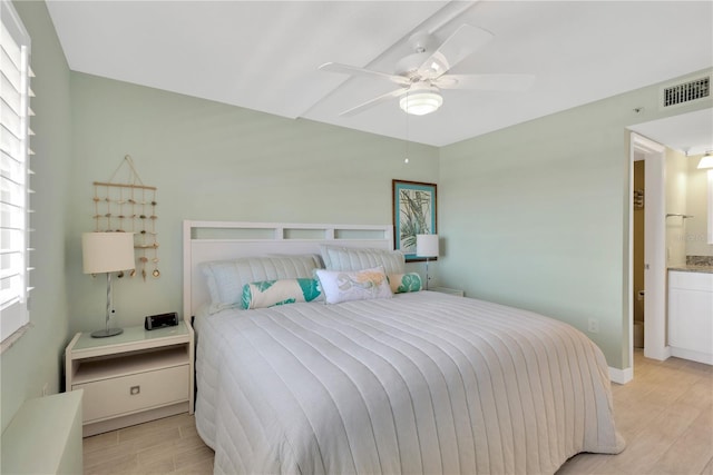 bedroom featuring light wood-type flooring, visible vents, and ceiling fan