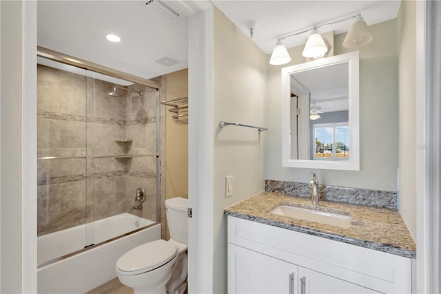 full bathroom with vanity, toilet, and bath / shower combo with glass door