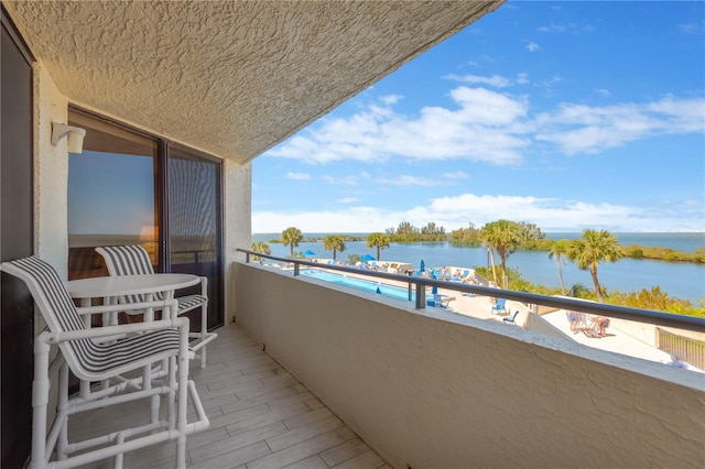 balcony featuring a water view