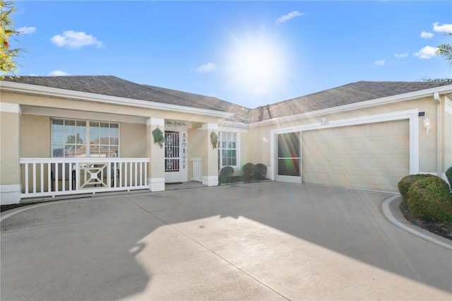 single story home with stucco siding, a garage, concrete driveway, and a shingled roof