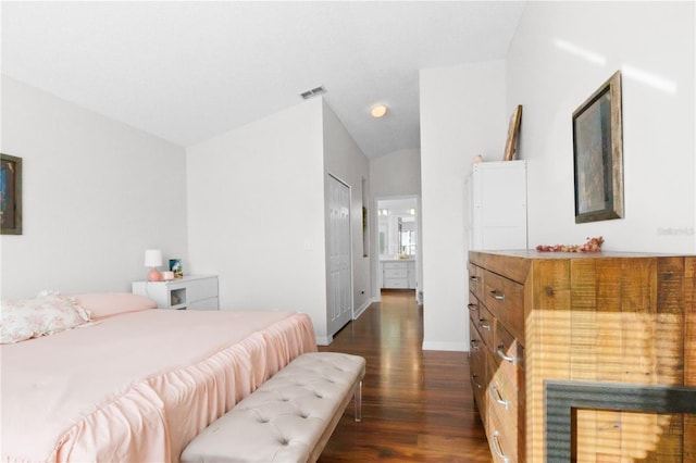 bedroom featuring visible vents, dark wood-type flooring, baseboards, and vaulted ceiling