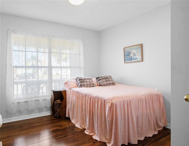 bedroom featuring dark wood finished floors