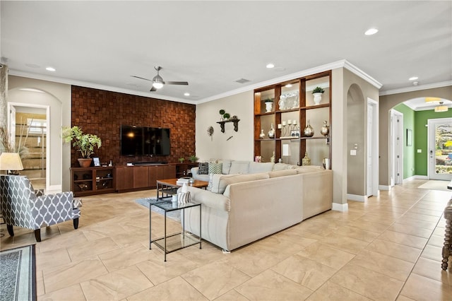 living area featuring a ceiling fan, visible vents, recessed lighting, arched walkways, and ornamental molding