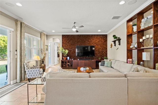 living area with visible vents, recessed lighting, arched walkways, ceiling fan, and crown molding