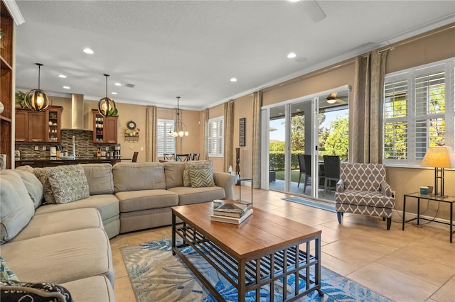 living room with crown molding, light tile patterned floors, recessed lighting, ceiling fan with notable chandelier, and a textured ceiling