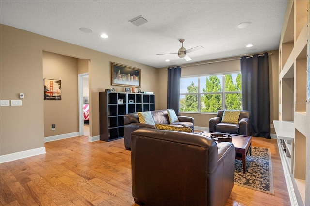 living area featuring recessed lighting, baseboards, ceiling fan, and light wood finished floors