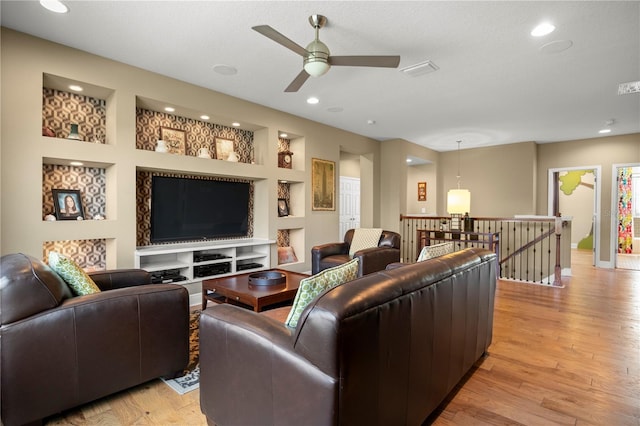 living area with light wood-style flooring, built in features, recessed lighting, and ceiling fan