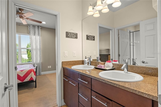 bathroom featuring double vanity, ceiling fan with notable chandelier, baseboards, and a sink