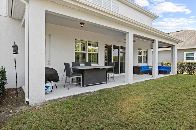 exterior space featuring stucco siding, a patio, a yard, outdoor lounge area, and ceiling fan