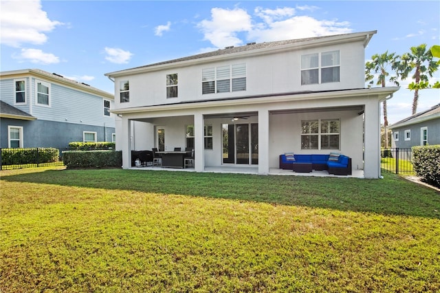 rear view of property with a patio, fence, an outdoor living space, a yard, and stucco siding