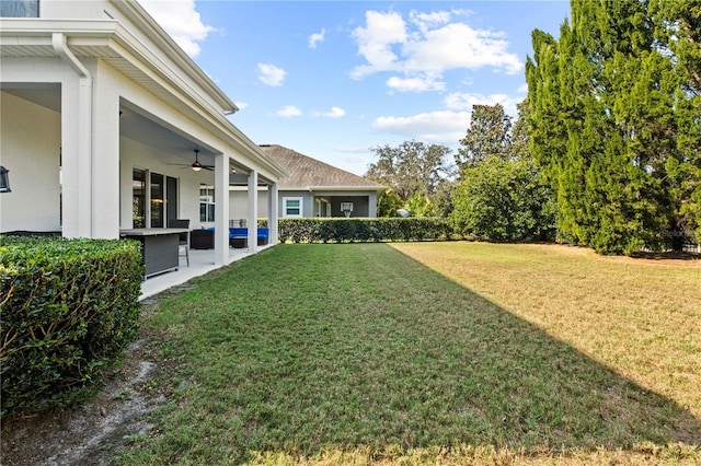 view of yard featuring a ceiling fan