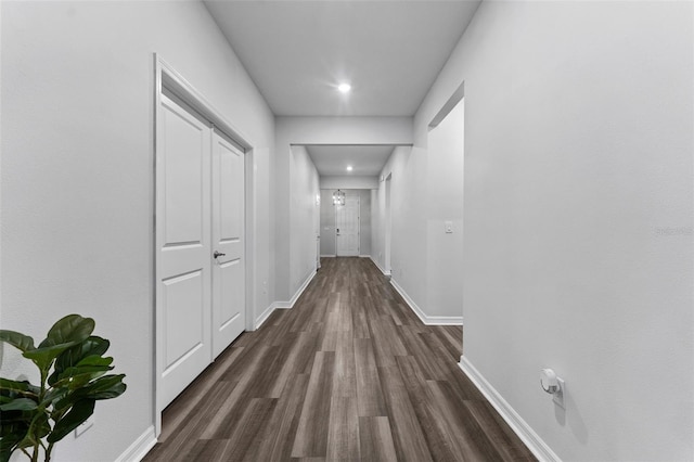 hall featuring dark wood finished floors and baseboards