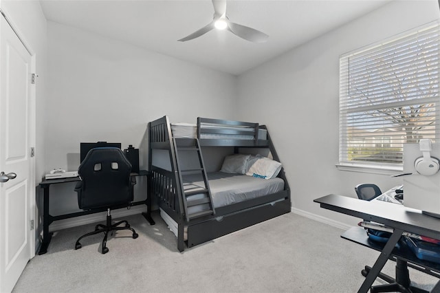 bedroom with a ceiling fan, baseboards, and carpet floors