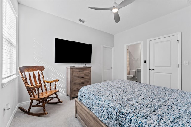 bedroom featuring visible vents, connected bathroom, baseboards, light carpet, and a ceiling fan