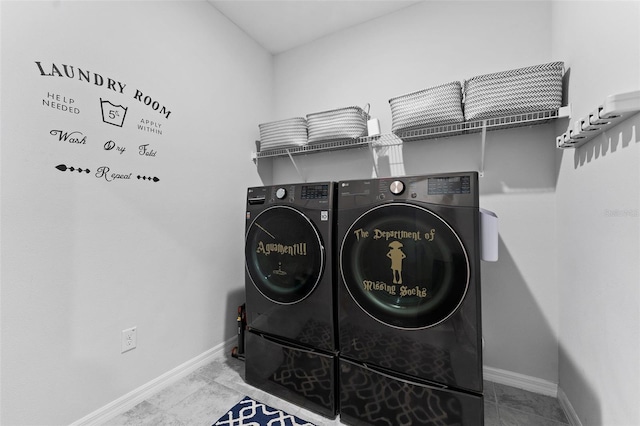 laundry area with laundry area, separate washer and dryer, and baseboards